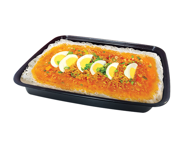 A black rectangular food tray containing a prepared noodle dish with a bright orange-red sauce, minced meat topping, chopped green herbs, and five sliced hard-boiled eggs arranged lengthwise on top, isolated on a white background.