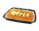 A black rectangular food tray containing a prepared noodle dish with a bright orange-red sauce, minced meat topping, chopped green herbs, and five sliced hard-boiled eggs arranged lengthwise on top, isolated on a white background.