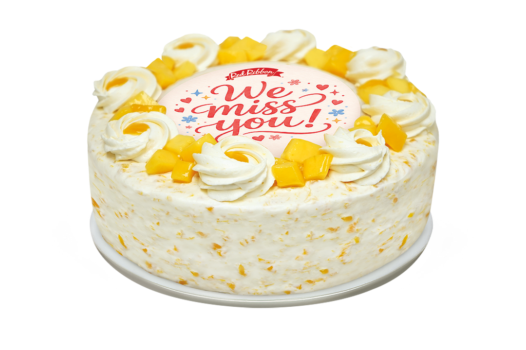 Cake with 'We miss you!' message on a white background